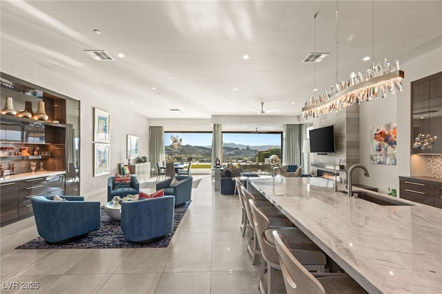 515 Serenity Point Dr, Henderson, NV 89012 - living room with light tile patterned flooring, recessed lighting, and bar with sink