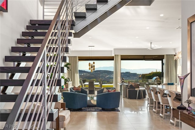 interior space with recessed lighting, ceiling fan, stairs, tile patterned flooring, and a mountain view