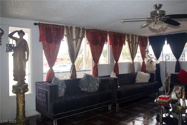 living room with ceiling fan and a textured ceiling