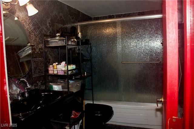 bathroom featuring vanity, toilet, and bath / shower combo with glass door