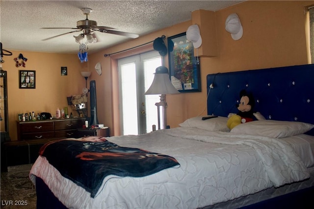 bedroom with a textured ceiling and a ceiling fan