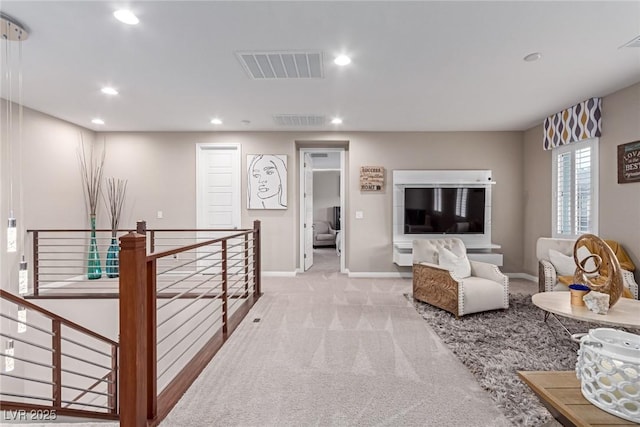 carpeted living room featuring recessed lighting, visible vents, and baseboards