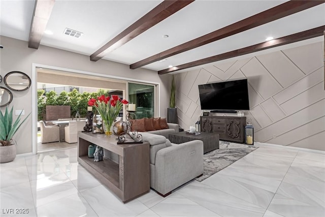 living area featuring visible vents, beam ceiling, marble finish floor, baseboards, and an accent wall