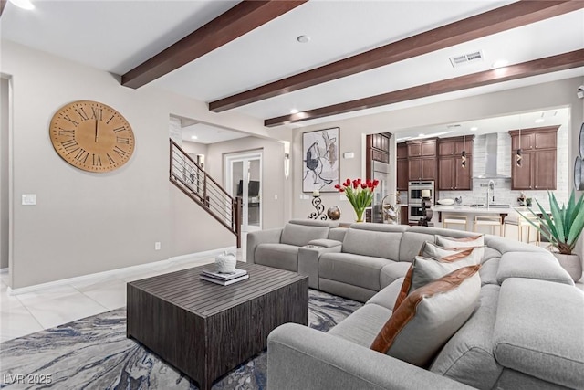 living room featuring visible vents, baseboards, beamed ceiling, stairs, and marble finish floor