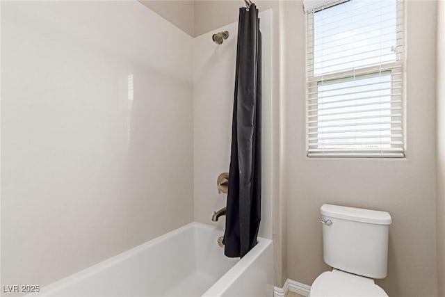 bathroom with shower / bath combination with curtain and toilet