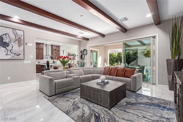 living area with beam ceiling, baseboards, visible vents, and marble finish floor