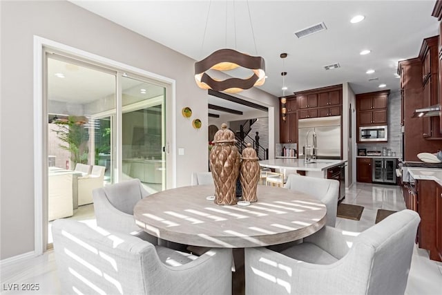 dining area featuring recessed lighting, visible vents, and wine cooler