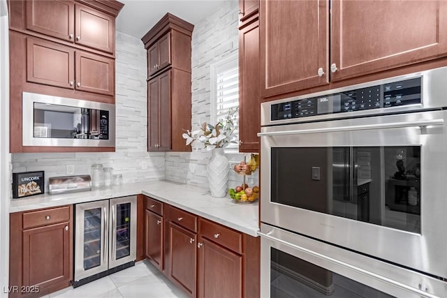 kitchen with backsplash, light stone countertops, built in microwave, wine cooler, and stainless steel double oven