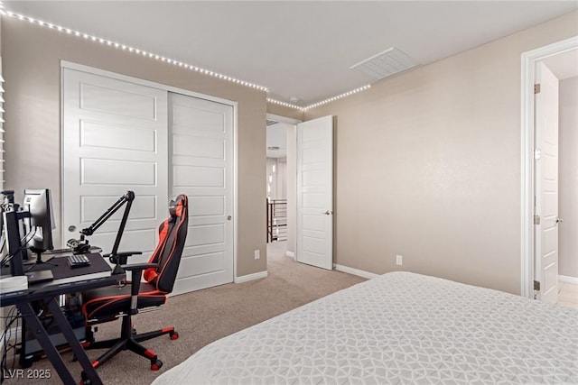 carpeted bedroom with a closet, visible vents, and baseboards