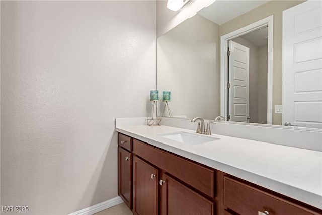 bathroom with vanity and baseboards