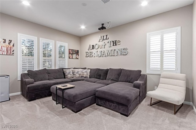 living room featuring recessed lighting, light colored carpet, and baseboards