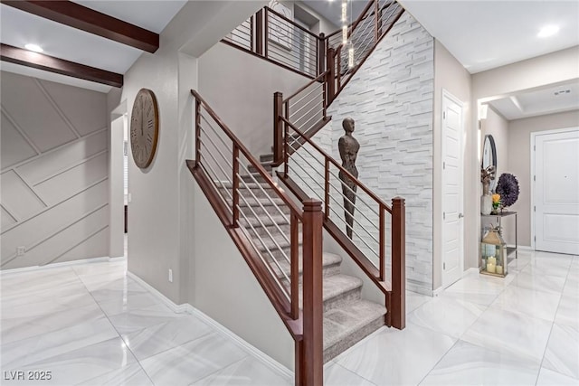 stairs with beam ceiling, baseboards, and marble finish floor