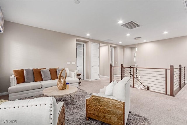 living area with recessed lighting, visible vents, carpet flooring, and baseboards