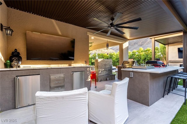 view of patio / terrace with outdoor lounge area, area for grilling, and a ceiling fan