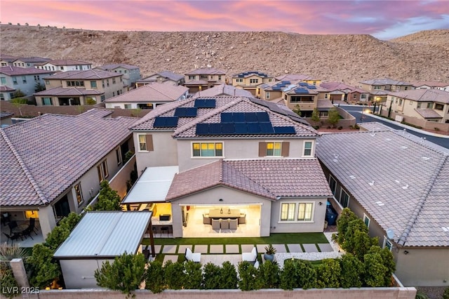 aerial view at dusk featuring a residential view