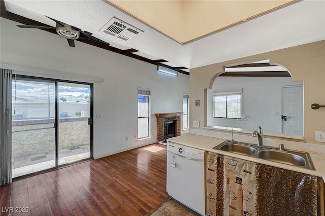 kitchen featuring visible vents, dark wood-type flooring, a ceiling fan, a sink, and white dishwasher