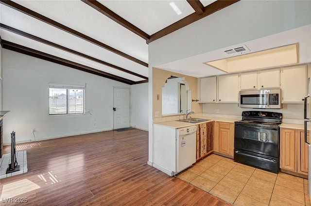 kitchen with stainless steel microwave, visible vents, black range with electric stovetop, white dishwasher, and a sink