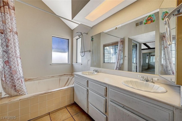 bathroom with a sink, a bathtub, tile patterned floors, and vaulted ceiling