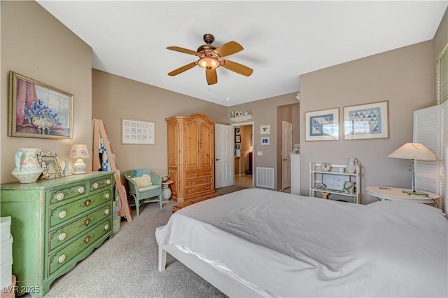 carpeted bedroom with visible vents and a ceiling fan