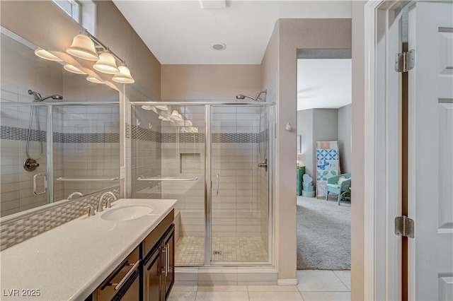 ensuite bathroom featuring vanity, a shower stall, tile patterned floors, and connected bathroom