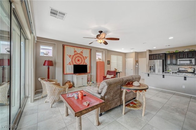 living room with light tile patterned flooring, visible vents, recessed lighting, and ceiling fan