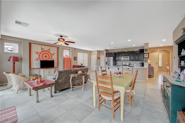 dining room with recessed lighting, visible vents, arched walkways, and light tile patterned floors