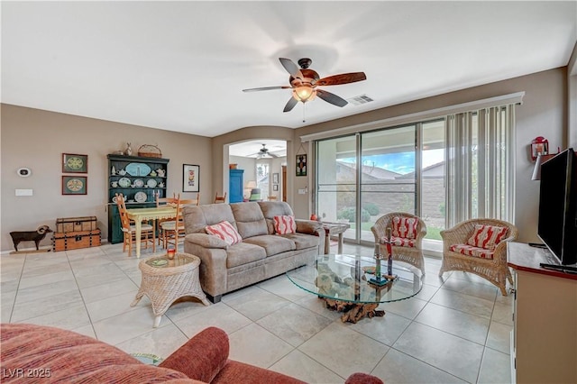 living room with light tile patterned floors, a ceiling fan, and visible vents