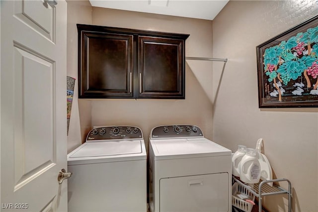 laundry area featuring cabinet space and washing machine and clothes dryer