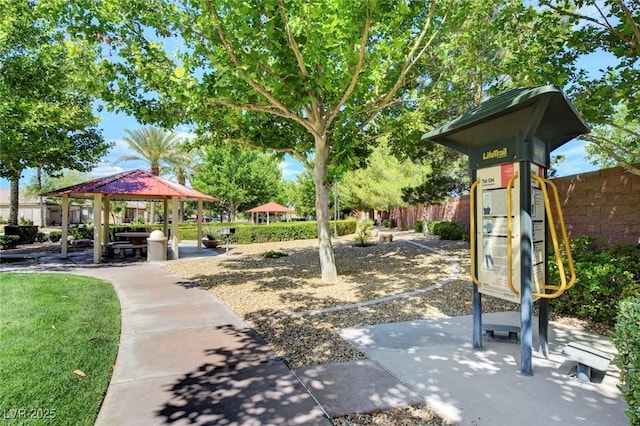 view of property's community with a gazebo, fence, and playground community