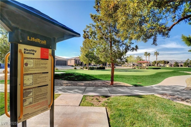 view of home's community with a yard