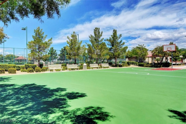 view of property's community with community basketball court and fence