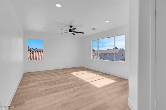 unfurnished room with light wood finished floors, visible vents, recessed lighting, and baseboards