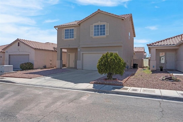 mediterranean / spanish-style home featuring stucco siding, a garage, concrete driveway, and a tile roof