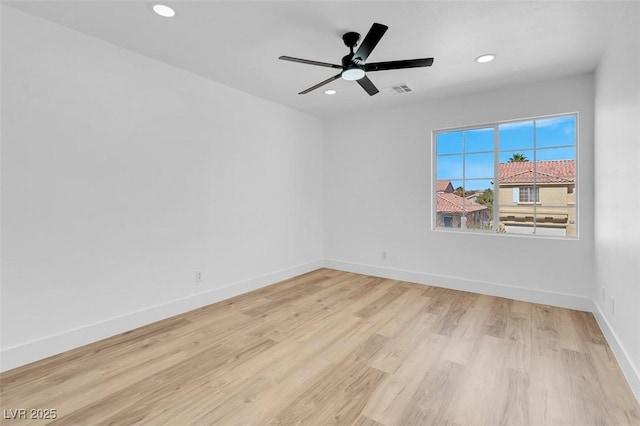 spare room with light wood-type flooring, visible vents, recessed lighting, baseboards, and ceiling fan