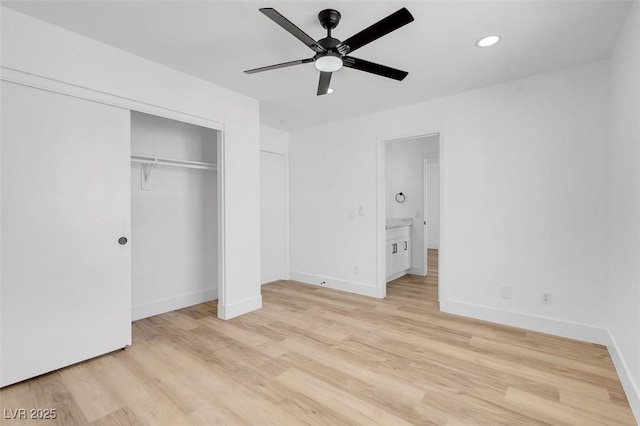 unfurnished bedroom with a closet, recessed lighting, baseboards, and light wood finished floors