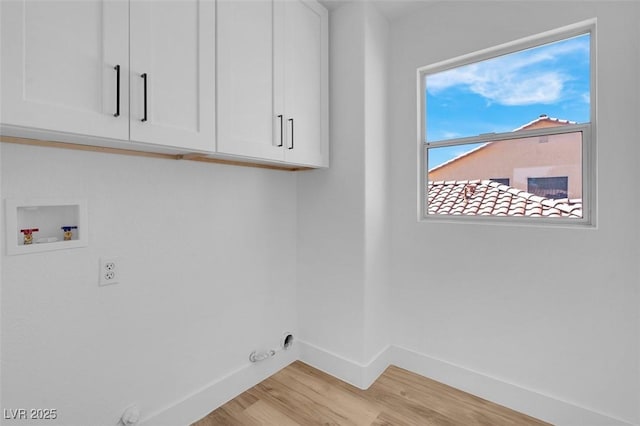 laundry area featuring baseboards, light wood-style flooring, cabinet space, washer hookup, and hookup for a gas dryer