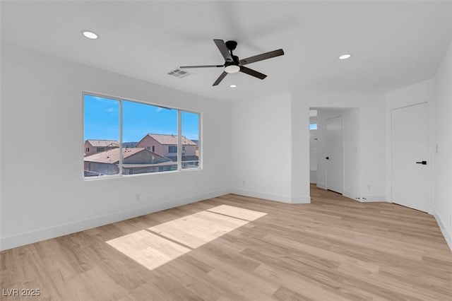 unfurnished room featuring recessed lighting, wood finished floors, visible vents, and baseboards