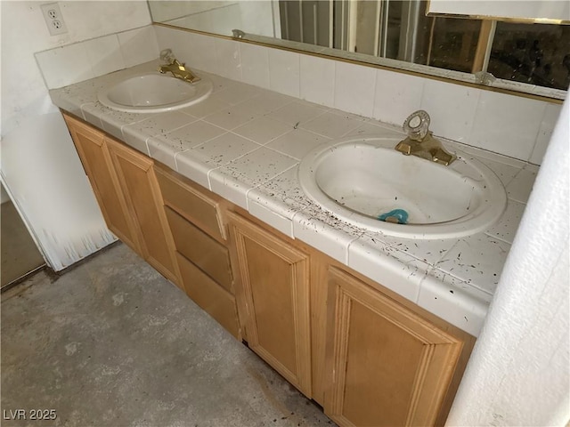 full bathroom with double vanity, backsplash, and a sink