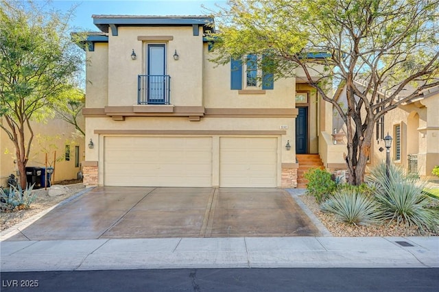 view of front facade with stucco siding, a garage, and driveway