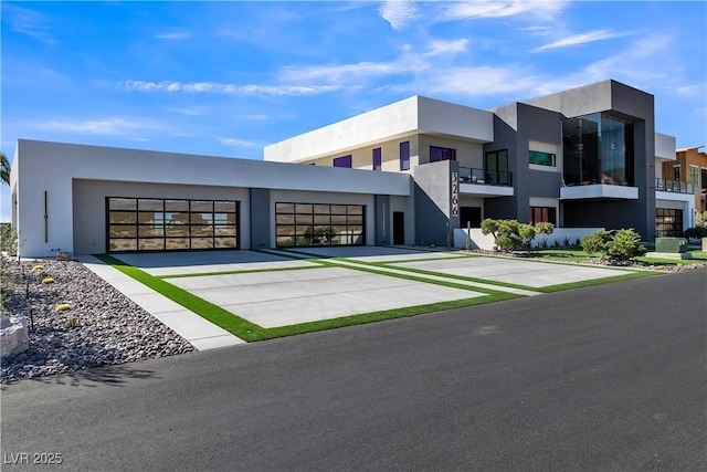 view of property featuring an attached garage and driveway