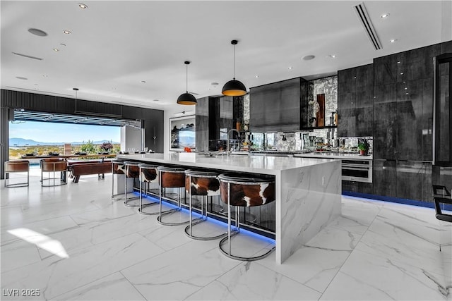 bar with recessed lighting, marble finish floor, pendant lighting, and stainless steel oven