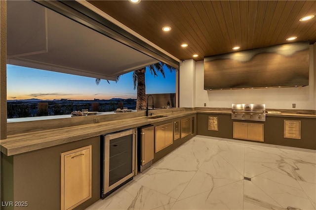 view of patio / terrace featuring an outdoor kitchen, area for grilling, beverage cooler, and a sink