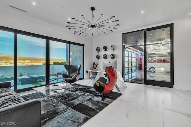 living room with a wealth of natural light, visible vents, marble finish floor, and a chandelier