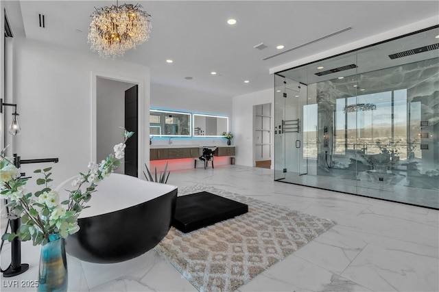 interior space featuring a sink, visible vents, and a chandelier