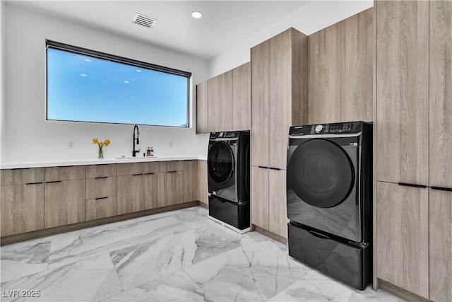 laundry area featuring visible vents, laundry area, marble finish floor, independent washer and dryer, and a sink