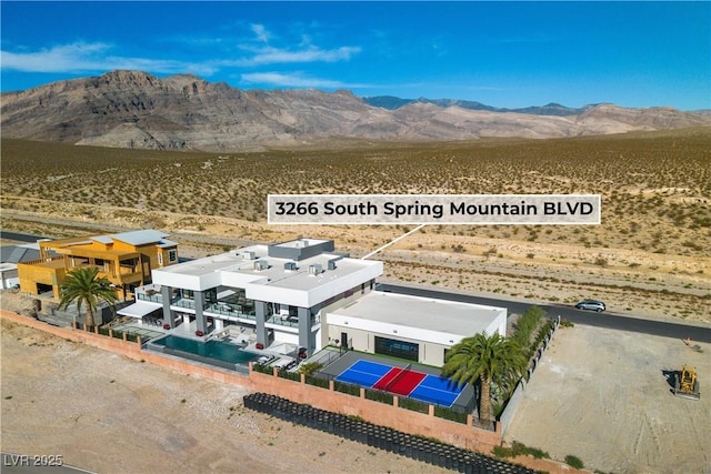 birds eye view of property featuring a desert view and a mountain view