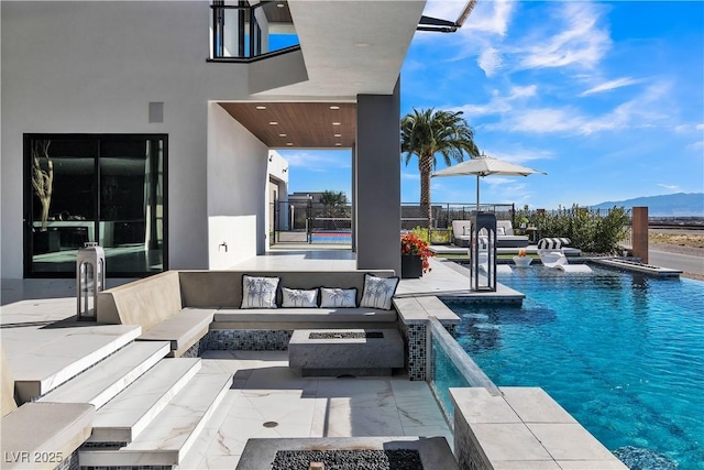 view of pool featuring a fenced in pool, an outdoor living space with a fire pit, and a patio