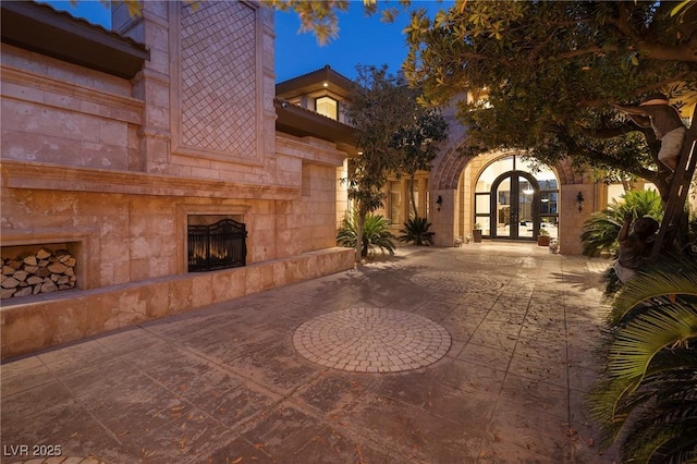 9801 Orient Express Ct, Las Vegas, NV 89145 - view of patio with french doors and a tile fireplace