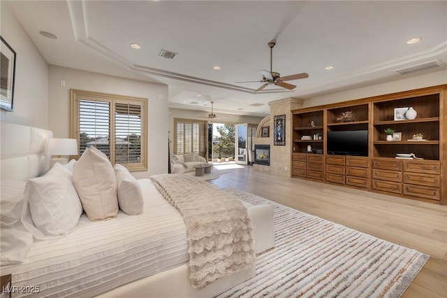 9801 Orient Express Ct, Las Vegas, NV 89145 - bedroom featuring recessed lighting, a large fireplace, light wood finished floors, and visible vents