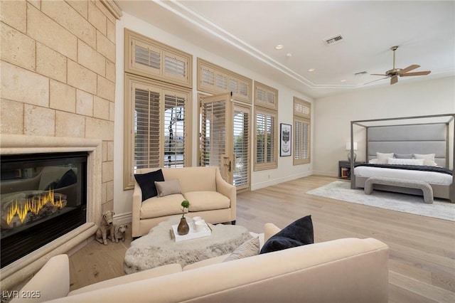 9801 Orient Express Ct, Las Vegas, NV 89145 - bedroom featuring baseboards, visible vents, a large fireplace, and wood finished floors